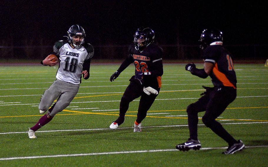 AFNORTH running back Nathan Goldsmith runs while Sentinel defenders Casey Supinger, center, and Cordrick Sago chase during the DODEA-Europe Division III championship game on Oct. 29, 2023, at Spangdahlem High School in Spangdahlem, Germany.