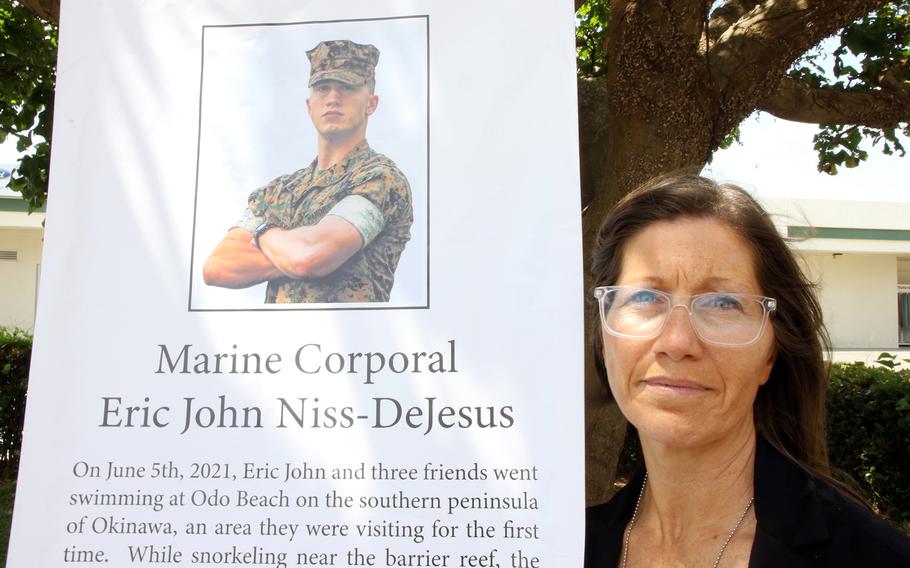 Jessica Niss poses with a photo of her son, Cpl. Eric John Niss de Jesus, at Camp Foster, Okinawa, May 24, 2023. Niss de Jesus, 24, drowned after getting caught in a rip current at Odo Beach, June 5, 2021.