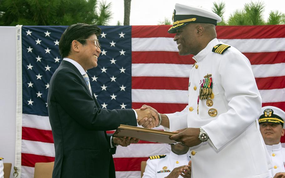 Sasebo Mayor Daisuke Miyajima presents Capt. David Adams with an honorary citizen award during a change-of-command ceremony at Sasebo Naval Base, Japan, Sept. 28, 2023. Adams was relieved by Capt. Michael Fontaine. 