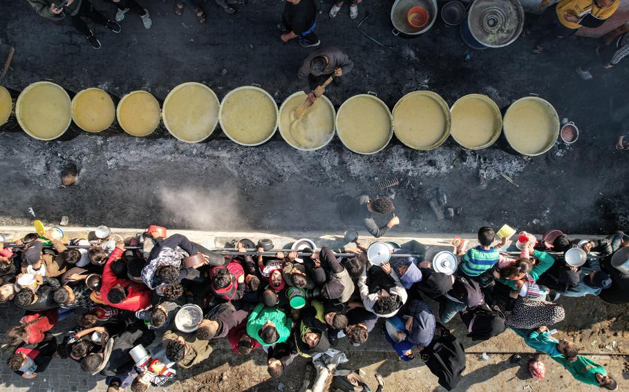 Crowds of displaced residents wait for a meal of lentil soup in Rafah, south of the Gaza Strip, on Dec. 18, 2023.