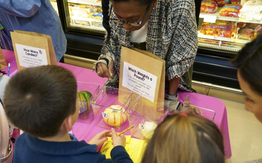 Arnn Elementary School math teacher Athea Carter leads a Math Night problem-solving event at the commisary in the Sagamihara Housing Area near Camp Zama, Japan, Nov. 16, 2023.