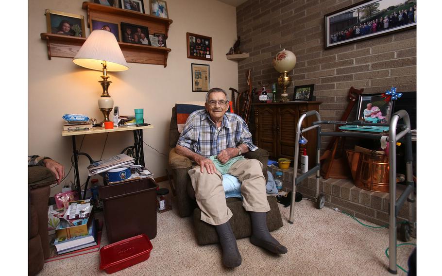 John Adams is surrounded with mementos of his life at his home in Plain Township, Ohio, on Jan. 26, 2022. The World War II veteran who fought in the South Pacific is among a dwindling number of Americans who served in the war.