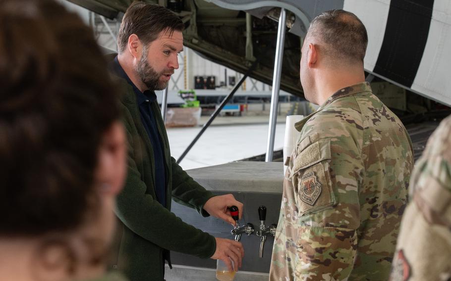 Vice President JD Vance pours beer for a service member