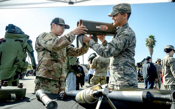 La Quinta High JROTC Christopher Lynn, 15, right, picks up a rocket launcher while assisted by Army Sgt. Willie Ouyang during the Army Career Fair at the Armed Forces Reserve Center near Moreno Valley on Tuesday, Oct. 24, 2023. (Photo by Watchara Phomicinda, The Press-Enterprise/SCNG)