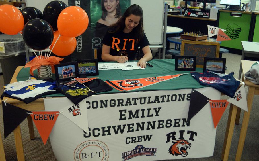 Emily Schwennesen signs paperwork.