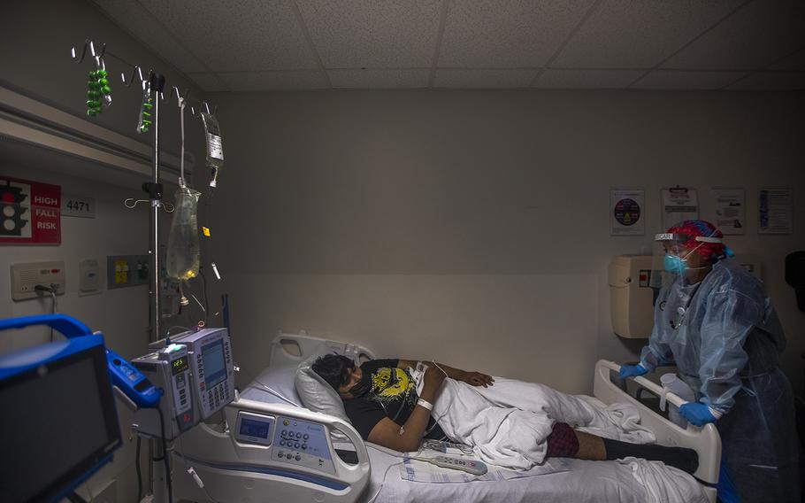 Dr. Anita Sircar takes a moment to talk with one of her COVID-19 patients, Angel Cordero, 19. “It’s the worst experience ever,” he said. 