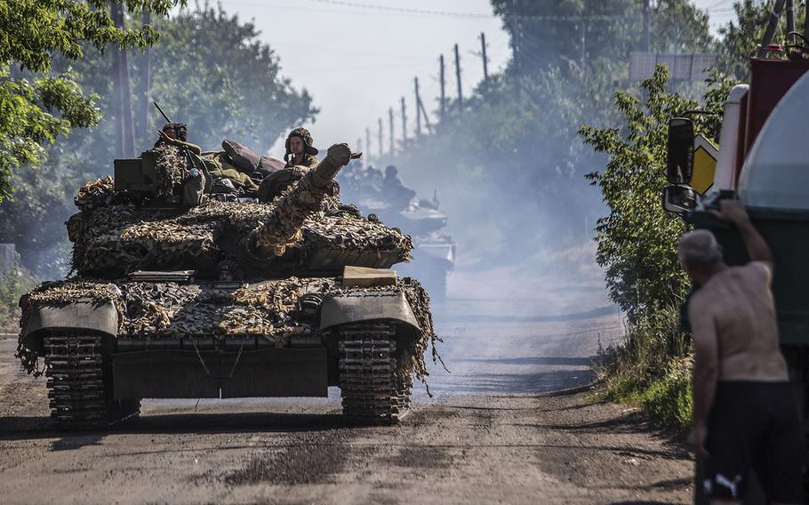 Ukrainian forces on tanks move along a road outside the eastern Ukrainian city of Lysychansk in June 2022.