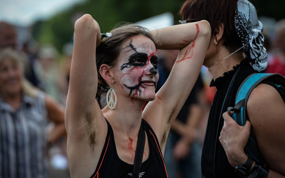 A protester with face paint listens to speakers at a “dance of the dead” protest against war in Ramstein-Miesenbach, Germany, June 25, 2022. 