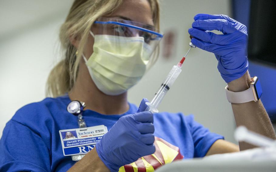 A nurse prepares medication to be administered to a COVID-19 patient in the Medical Intensive Care Unit at Jackson Memorial Hospital on July 23, 2021, in Miami.