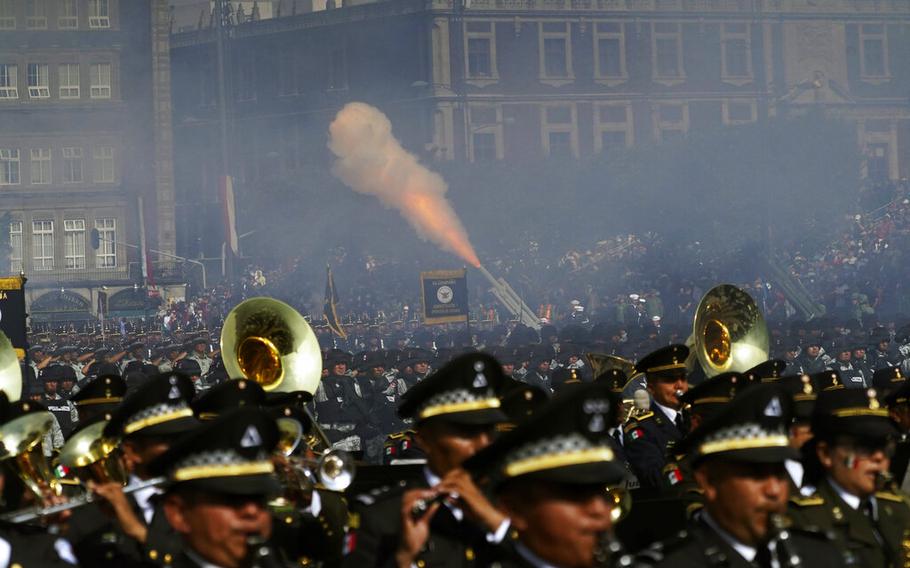 Soldiers fire ceremonial rounds from cannons as part of the annual Independence Day military parade at the main square, the Zocalo, in Mexico City, on Friday, Sept. 16, 2022. 