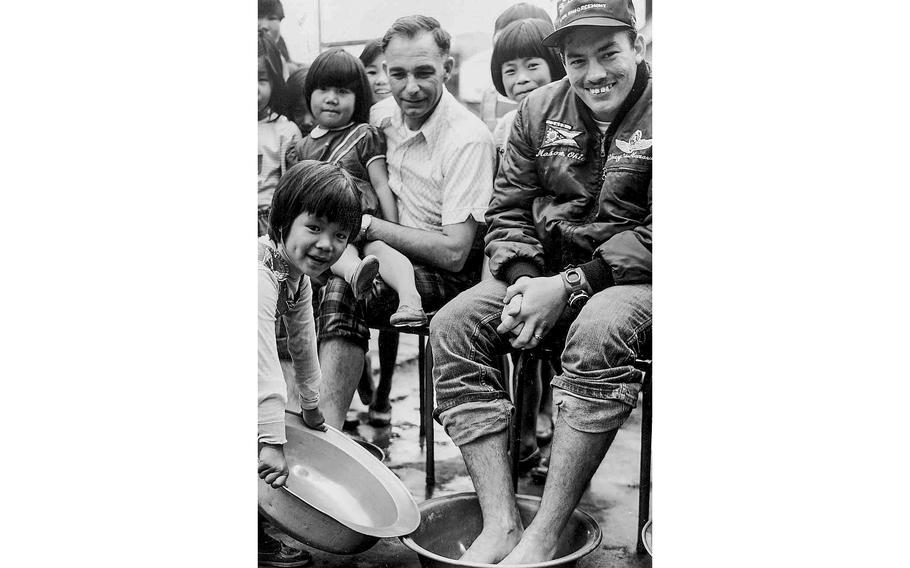 South Korea, 1974: Sgt. Kenneth L. Simons, right, and Sgt. Marvin Perham, with the 3rd Security Police squadron at Kunsan Air Force Base, rest their weary feet after completing a 20-mile walk-a-thon to raise money for the Sam Sung Orphanage.