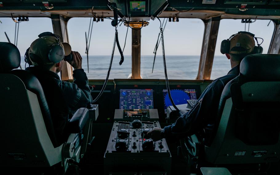 Lt. Austin Gooder, left, and Lt. Cole Roberts stand junior officer and officer of the deck aboard Independence-variant littoral combat ship USS Montgomery during routine underway operations in the eastern Pacific Ocean on April 14, 2022.