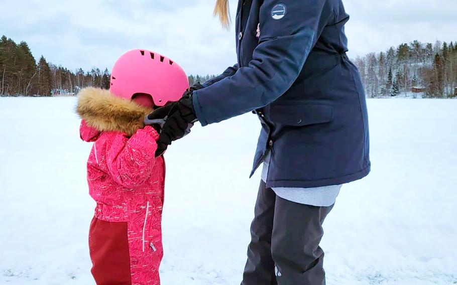 Liisi Hatinen teaches her daughter how to ice skate on Lake Kuolimo. 