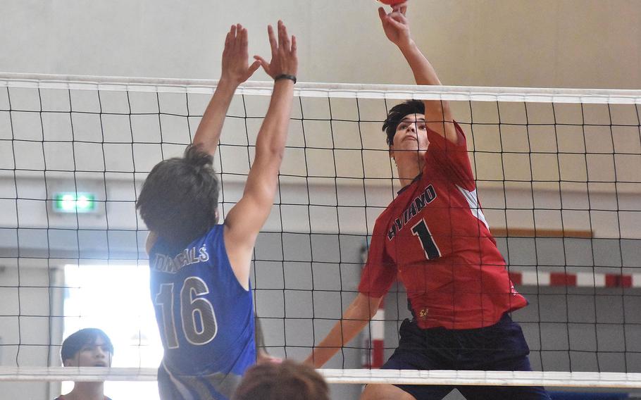 Aviano’s Xavier Fox tips the ball over the net and past a Rota block in a match against the Admirals on Saturday, Oct. 14, 2023. 