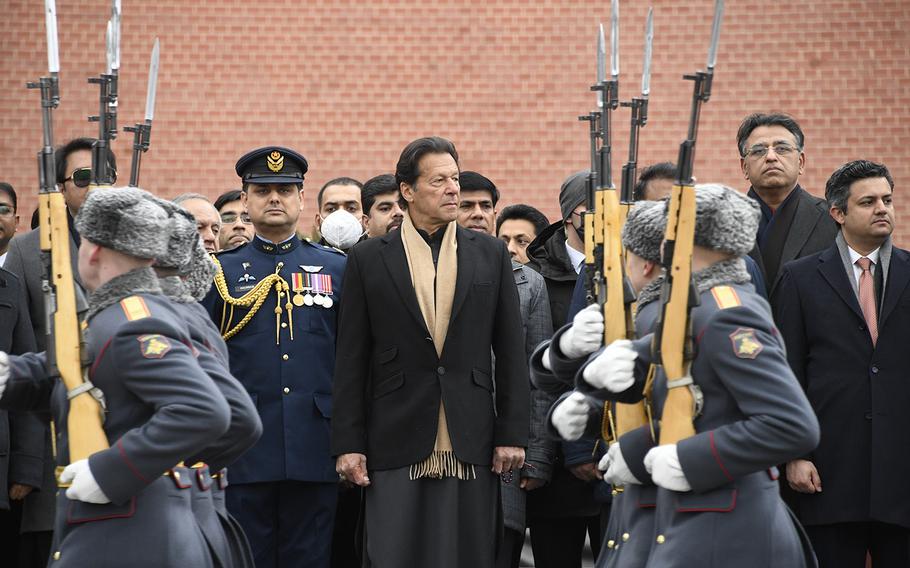 Pakistan’s then-Prime Minister Imran Khan, center, takes part in a wreath-laying ceremony at the Tomb of the Unknown Soldier at the Kremlin Wall in Moscow, Russia, on Feb. 24, 2022. 
