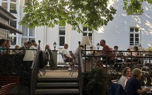 Diners enjoy the shade of the more than 170-year-old chestnut trees at Zum Goldstein in Mainz, Germany.