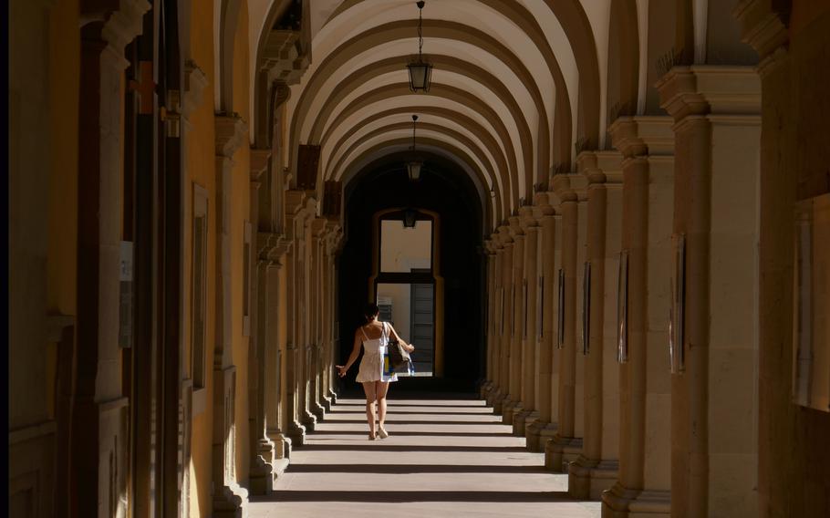 A woman walks along the colonnade of the Juliusspital in Wuerzburg, Germany. 
