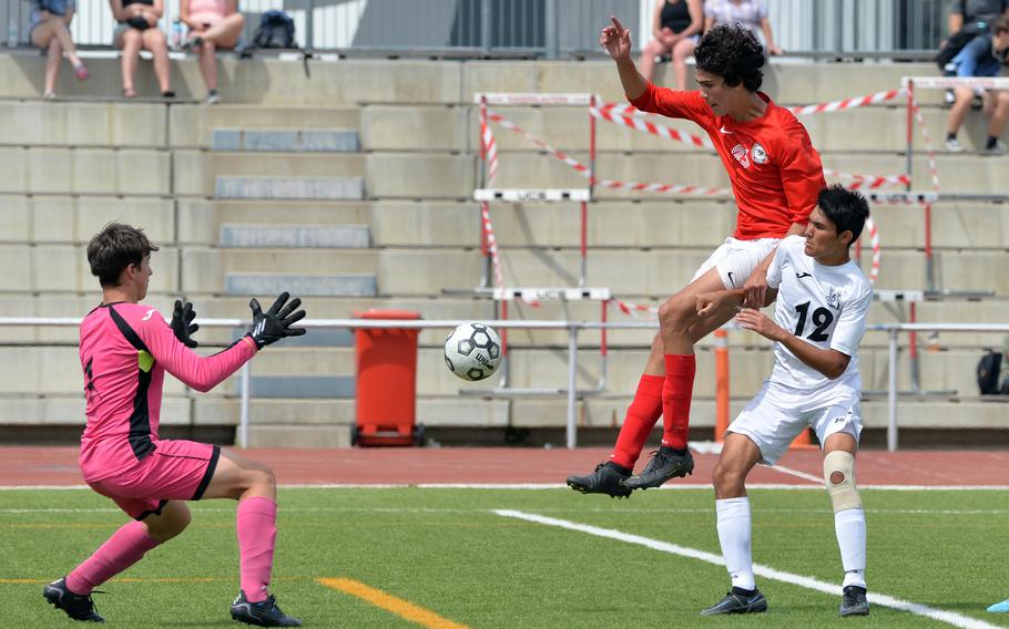 Naples keeper Alex Althafer gets ready to stop a shot by AOSR’s Renato Mauro Boccanelli as teammate Tommy Egan helps out in the boys Division II final at the DODEA-Europe soccer championships in Kaiserslautern, Germany, Thursday, May 19, 2022. Naples defeated their Italy rivals 1-0.