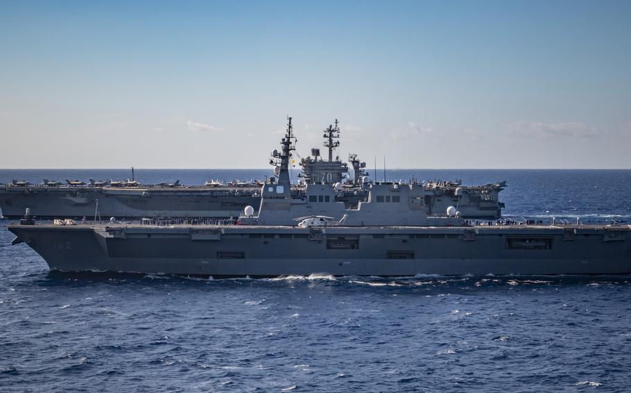 The aircraft carrier USS Carl Vinson sails alongside the Japanese helicopter destroyer JS Ise in the Philippine Sea, Jan. 31, 2024. 