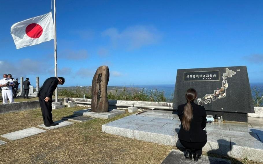 Japanese visitors pray at a war memorial atop Mount Suribachi dedicated to Japan's war dead from the Battle of Iwo Jima during the Reunion of Honor ceremony March 25, 2023, at Iwo Jima, Japan. 