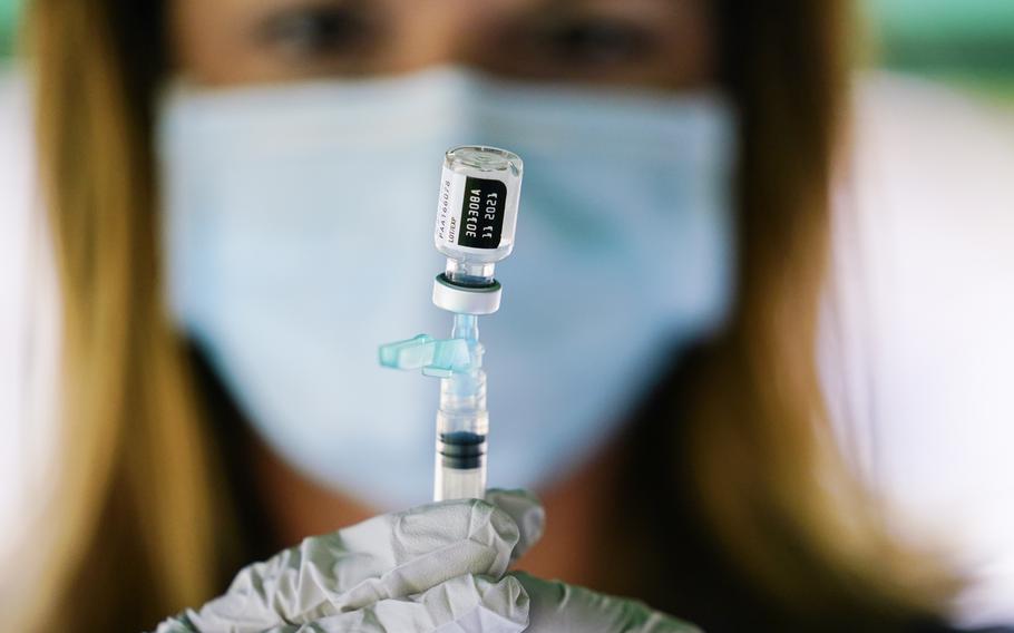 A syringe is prepared with the Pfizer COVID-19 vaccine at a clinic at the Reading Area Community College in Reading, Pa., Sept. 14, 2021. COVID-19 deaths and cases in the U.S. have climbed back to where they were over the winter.