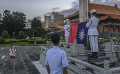 Soldiers lower the Taiwanese flag during a ceremony at the Chiang Kai-shek Memorial Hall in Taipei, Taiwan. on Aug. 4, 2022. 