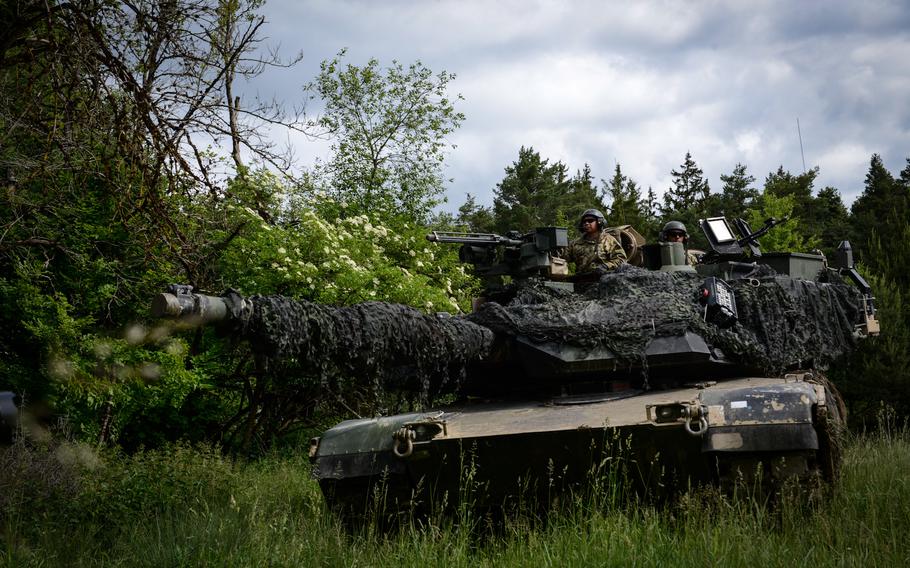 U.S. soldiers assigned to 10th Brigade Engineer Battalion, 1st Armored Brigade Combat Team, 3rd Infantry Division guard an intersection with their M1A2 Abrams as part of Combined Resolve 17, in the Hohenfels Training Area, Germany, June 8, 2022.