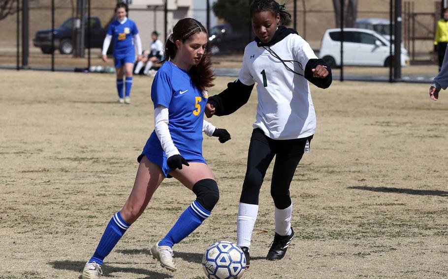Yokota's Hailiey Clark gets set to boot the ball past Robert D. Edgreni's Devonia James during Saturday's DODEA-Japan girls soccer match. The Panthers won 8-0.