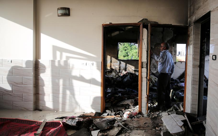 Zakaria Hamad inspects the inside of his home, which was destroyed by an airstrike in Beit Hanoun, Gaza. 