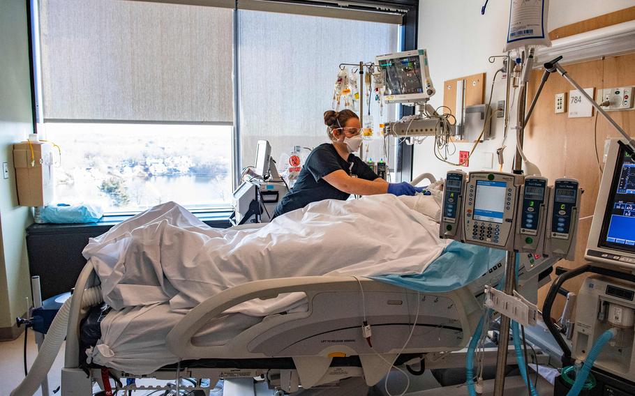 A medical worker treats a patient in the ICU ward at UMass Memorial Medical Center in Worcester, Massachusetts, on Jan. 4, 2022. 