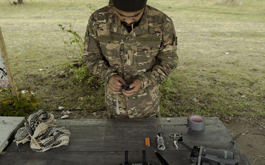 A Ukrainian volunteer soldier trains with a Mavic drone.