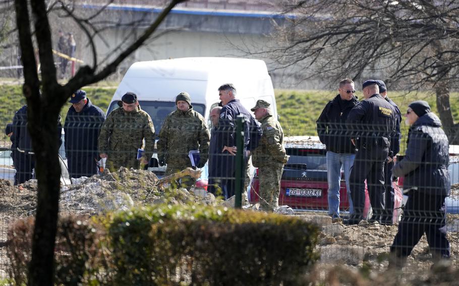 Police inspect site of a drone crash in Zagreb, Croatia, Friday, March 11, 2022. A drone that apparently flew all the way from the Ukrainian war zone crashed overnight on the outskirts of the Croatian capital, Zagreb, triggering a loud blast but causing no injuries, Croatian authorities said Friday. 