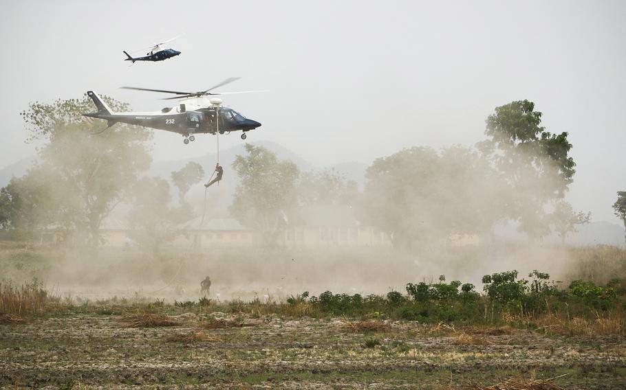 Nigerian special operations forces repel from a helicopter during a military demonstration at the African Land Force Summit in Abuja, Nigeria, April 17, 2018. The State Department announced the U.S. will sell Nigeria attack helicopters and related gear worth nearly $1 billion to bolster security in a region facing threats from multiple extremist groups.