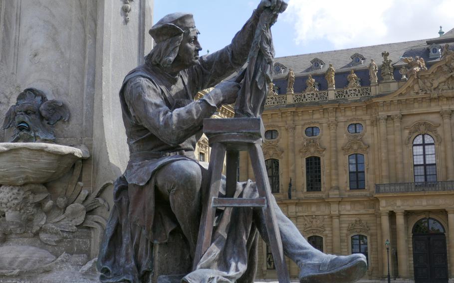 The statue of the great German sculptor Tillman Riemenschneider on the Franconia Fountain in front of the Residenz palace in Wuerzburg, Germany. 