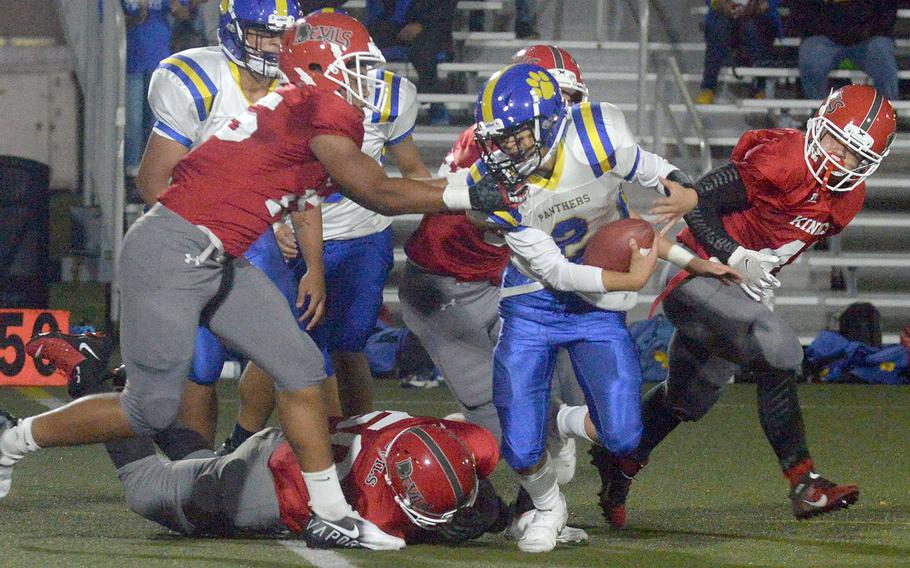 Yokota quarterback Dylan Tomas looks for running room against the Nile C. Kinnick defense.