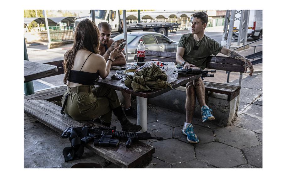 Israeli reservists outside a closed cafe in Kiryat Shmona. 