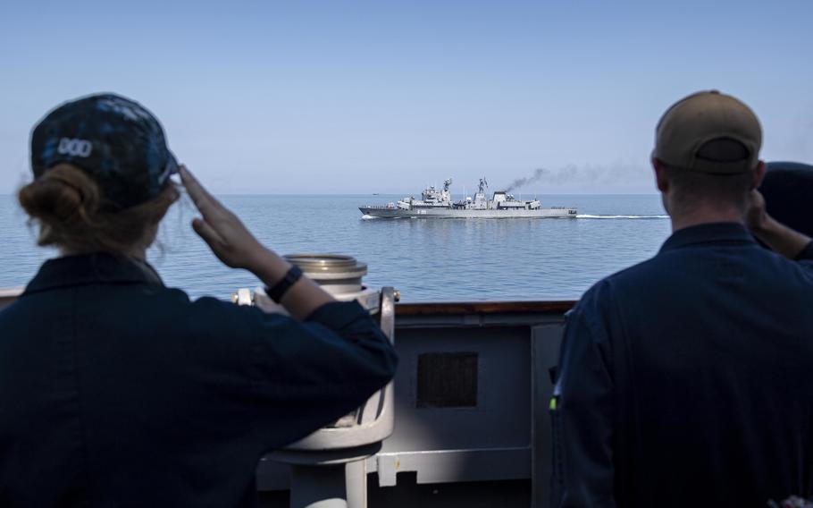 Sailors assigned to the destroyer USS Laboon salute as Laboon renders honors to the Romanian navy frigate ROS Marasesti during a passing and communication exercise in the Black Sea, June 23, 2021. 