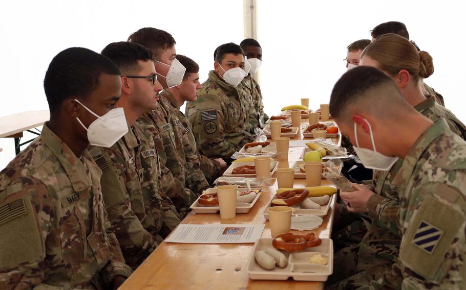 Soldiers with the 1st Armored Brigade Combat Tea, 3rd Infantry Division await the green light to eat their Bavarian breakfast at Grafenwoehr Training Area, Germany, March 11, 2022. 