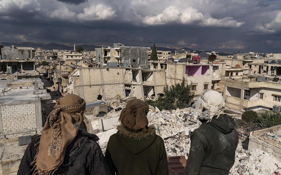 Locals from neighboring villages who came to Jinderis, Syria, to help view the destruction on Friday, Feb. 10, 2023, caused by major earthquakes. 