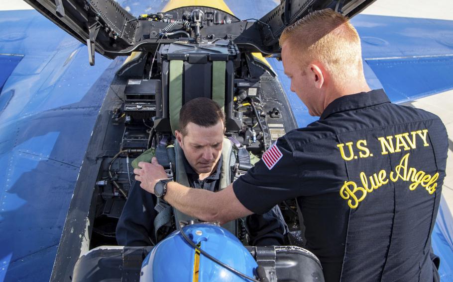 Harley Hall II, son of Vietnam veteran Harley H. Hall, gets strapped into an F/A-18 Super Hornet jet in preparation for a 45-minute flight at a Navy air show in Southern California.