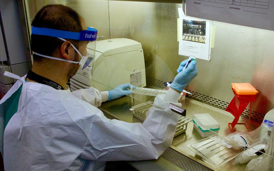 A scientist analyzes samples for the presence of the monkeypox virus, Aug. 30, 2022, at the Naval Medical Research Center’s Naval Infectious Diseases Diagnostic Laboratory in Silver Spring, Md.