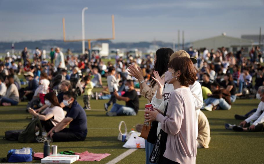 Japanese visitors listen to the 7th Fleet Band at Berkey Field during the 44th Friendship Day celebration at Yokosuka Naval Base, Japan, Sunday, Oct. 16, 2022. 