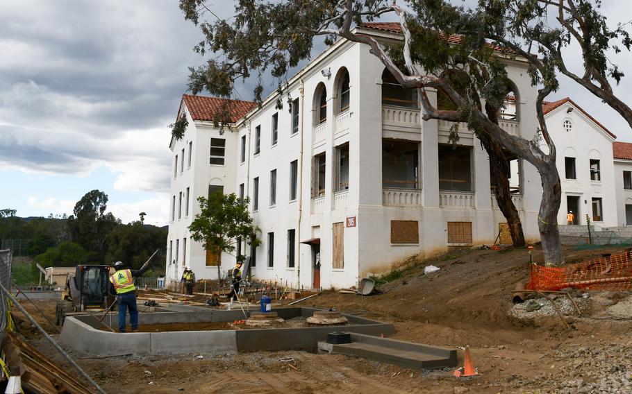 Construction workers restore a 1920s-era building on the Department of Veterans Affairs campus in West Los Angeles on Feb. 23, 2022. Two buildings on VA grounds were being made into housing units for homeless veterans, with each set to contain 50 apartments. The work is part of a larger master plan that assists the VA in determining the most effective use for the 388-acre campus.