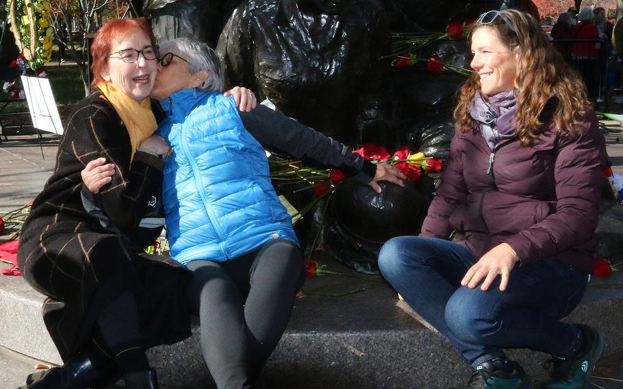 Diane Carlson Evans, left, whose efforts led to the creation of the Vietnam Women’s Memorial, gets a kiss from another vet on Nov. 11, 2023, on the 30th anniversary of the memorial’s dedication.