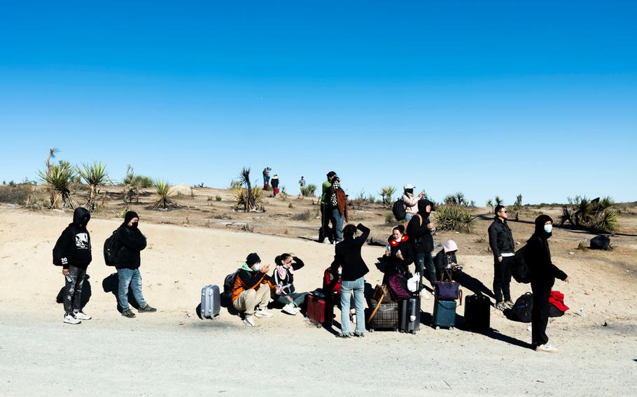 Migrants waiting to be processed by US Customs and Border Protection officers near the U.S.-Mexico border in Jacumba Hot Springs, Calif., on Nov. 7, 2023.