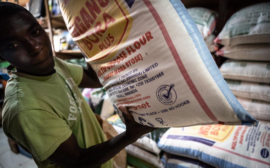 A man poses with a bag of wheat flour at a shop in Kigali, Rwanda, on March 23, 2022. The price of wheat flour has risen significantly, impacting the Rwandan market by Russia's invasion of Ukraine, as Rwanda imports 64% of wheat from Russia, according to the Rwandan Prime Minister.