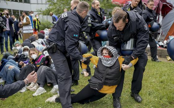A woman is carried away by police officers during a pro-Palestinian demonstration at the Free University in Berlin on May 7, 2024.