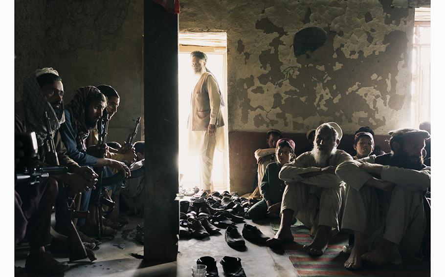 Farmers and Taliban gunmen gather in a former Islamic State courtroom in Baghdara. Islamic State fighters brutally enforced their will there after arriving from Pakistan in 2017.