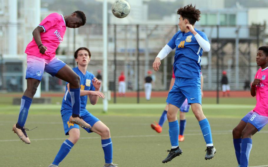 Nile C. Kinnick's Koboyo Awesso heads the ball in front of Yokota's Kai Patton and Adrien Ekiert during Thursday's DODEA-Japan/Kanto Plain boys soccer match. The Red Devils won 2-0.