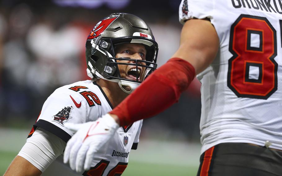 Tampa Bay Buccaneers quarterback Tom Brady celebrates with tight end Rob Gronkowski after the two connected on a touchdown against the Atlanta Falcons during an NFL football game, Sunday, Dec 5, 2021, in Atlanta. (Curtis Compton/Atlanta Journal-Constitution via AP)